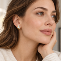 
Starburst pearl earrings worn on ear