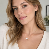 Freshwater pearl pendant necklace worn on neckline